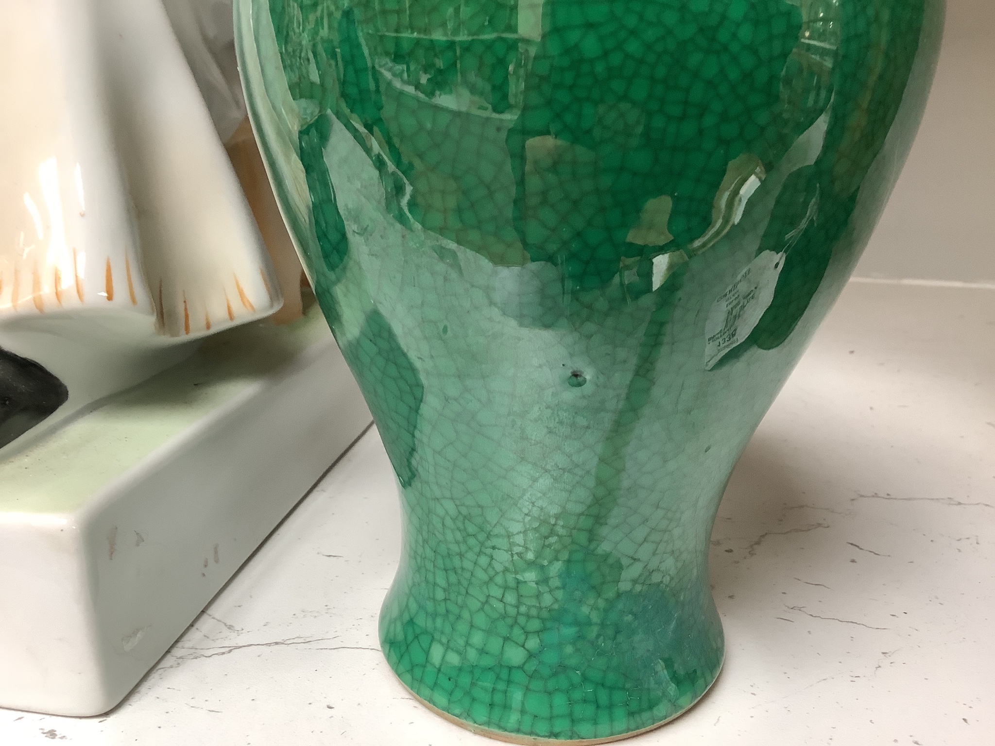 A Chinese green ground crackle glazed porcelain baluster vase, height 19cm